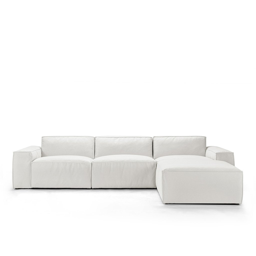 White modular sectional sofa with chaise on left side, modern design.