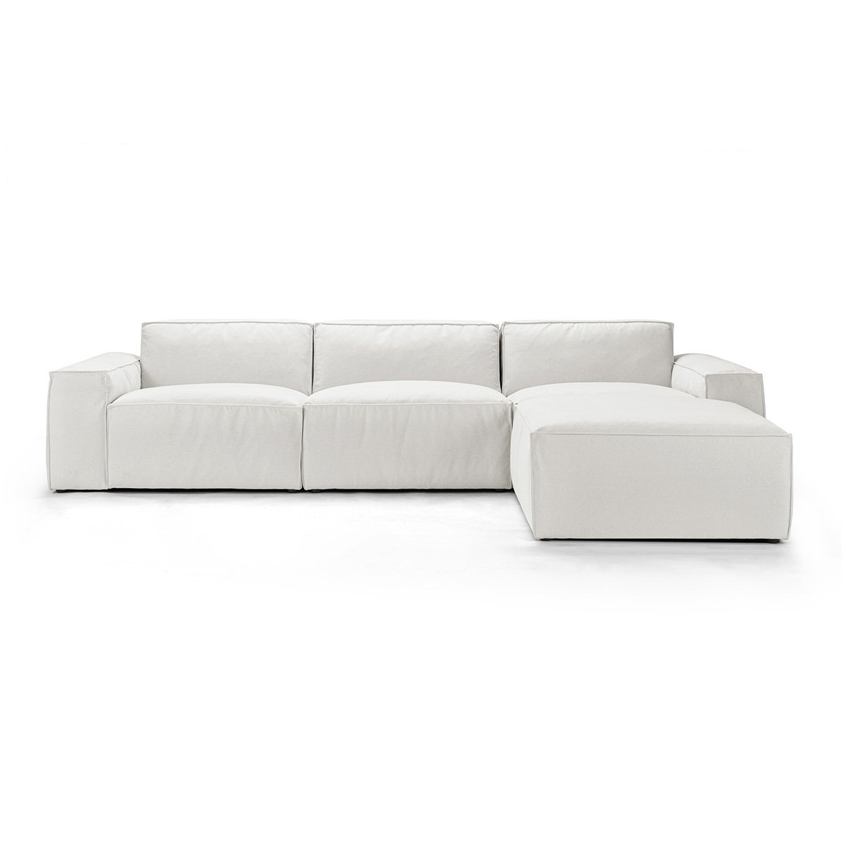 White sectional sofa with low back and clean lines in a bright studio, no background clutter.