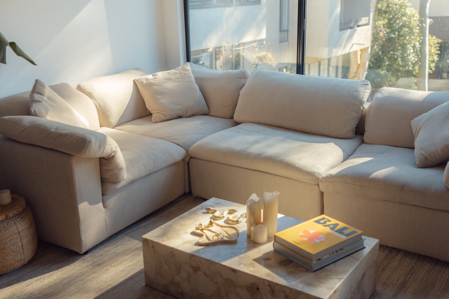 The EM Sky Sofa in a bright living room bathed in natural light, with plush cushions inviting relaxation.