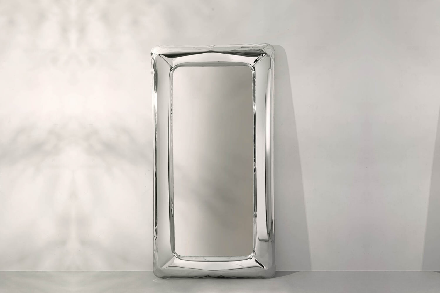 Tafla Contemporary Full-Length Polished Stainless Steel Framed Metallic Mirror, featuring a reflective, wavy frame, creating a modern, fluid appearance.
