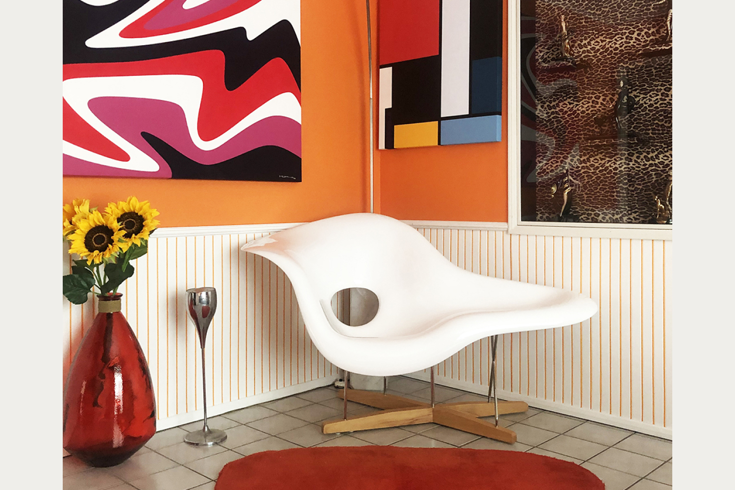 La Chaise Chair is showcased amidst a vibrant array of colors in the surrounding environment.