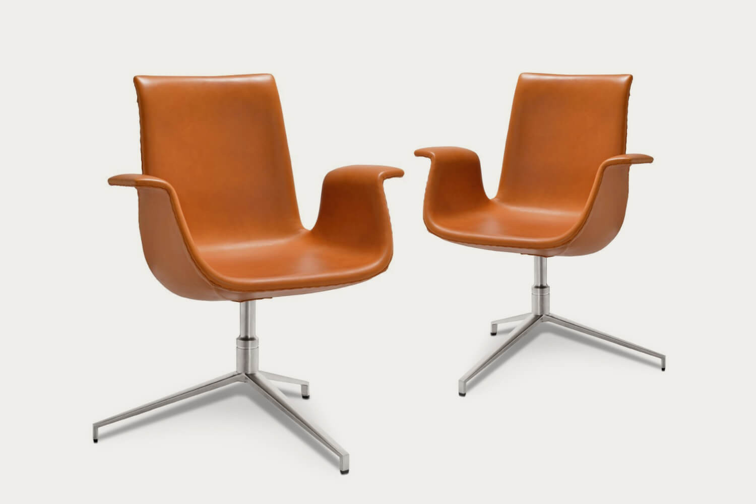 Two mid-century modern caramel brown Fk 6726 Bucket Chairs - Classic Edition, isolated against a white background.