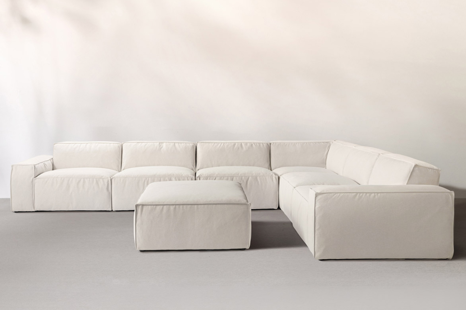 An 'Oasis Modern Low Profile Sofa in Latex' is featured, presenting a sleek and minimalist design.