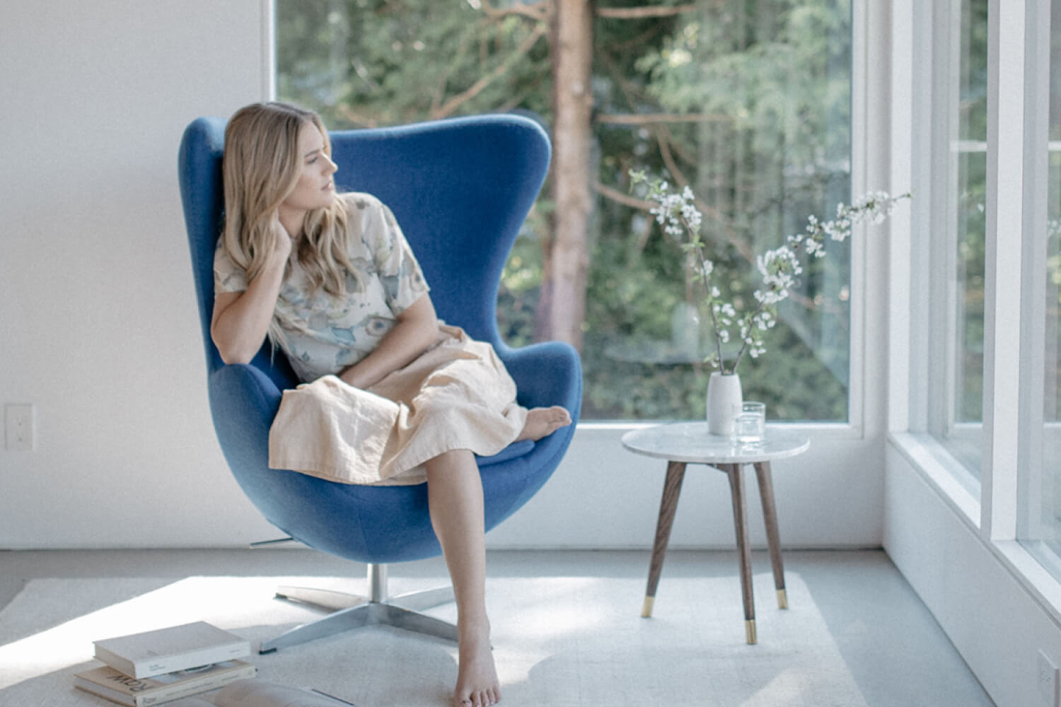 An image of a woman relaxing in an Egg Chair by Eternity Modern. 